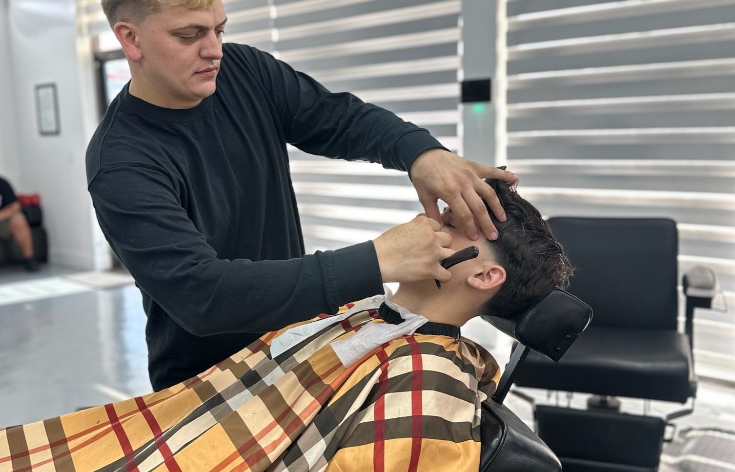 Sage The Barber working on a lineup at his chair in Stuart, FL